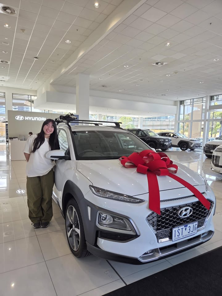 Client with new Hyundai in showroom