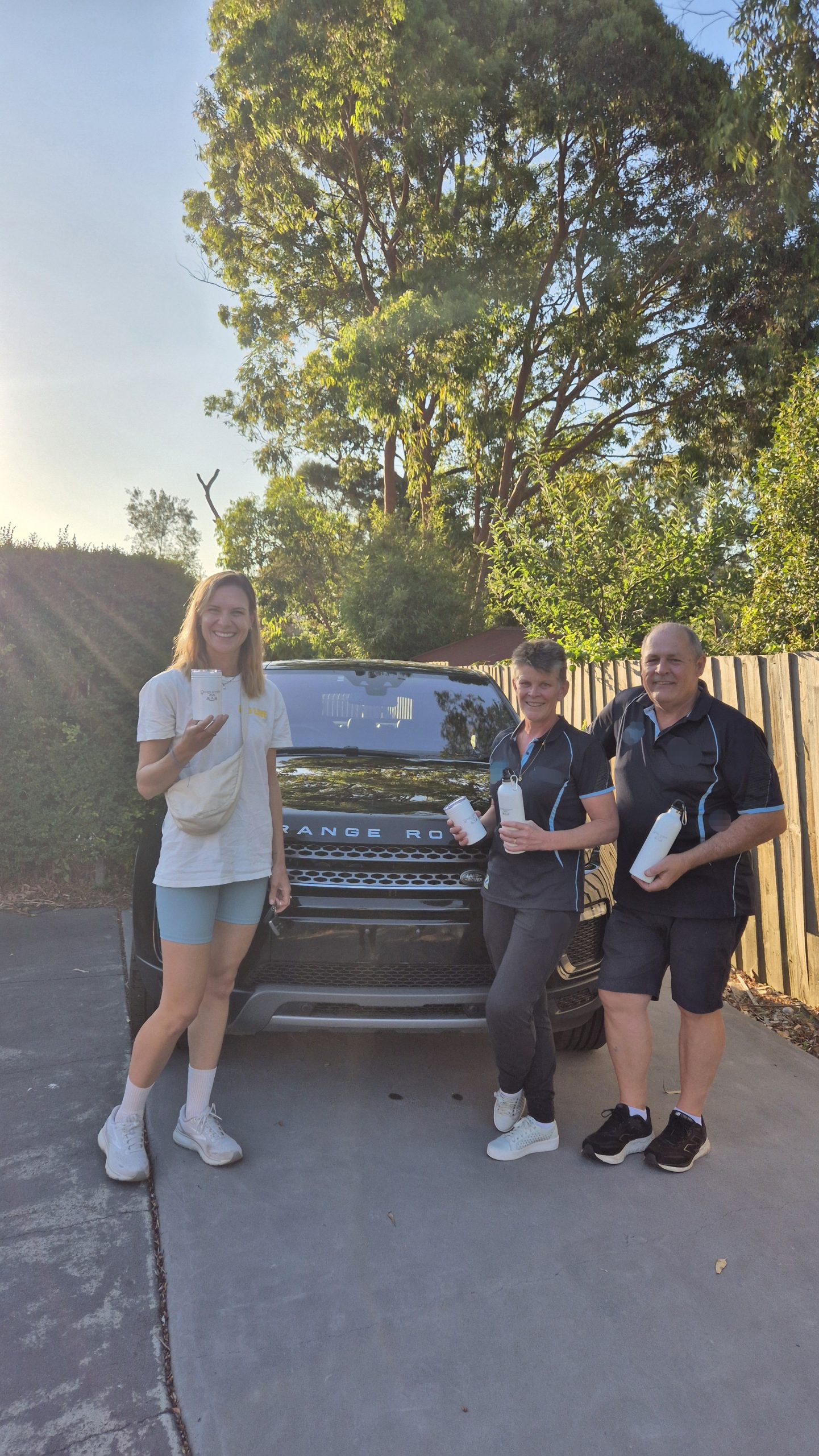 Advisor with clients in front of their new van